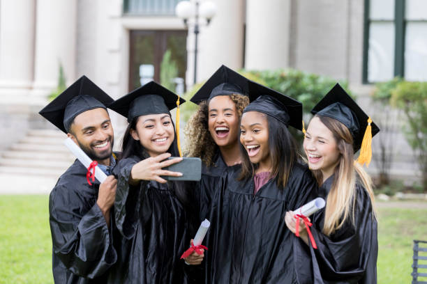 istock Playful group of grads posing for selfie 1041147984