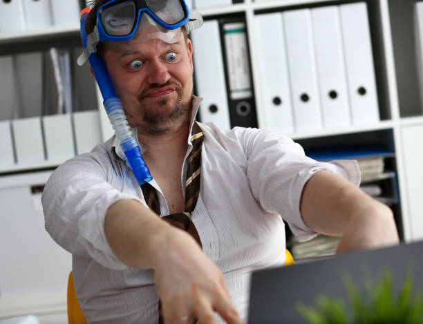 istock Man wearing suit and tie in goggles and snorkel 1041148608