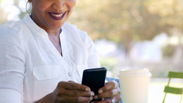 istock Active senior woman uses mobile app on smartphone 1041148892