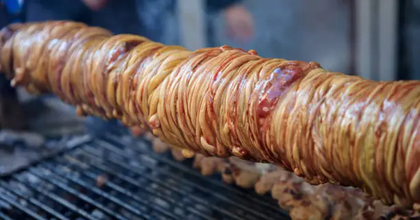 Grilling traditional Turkish food kokorec