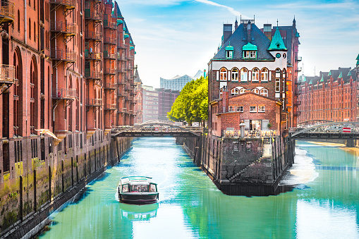 Hamburg Speicherstadt with sightseeing tour boat in summer, Germany