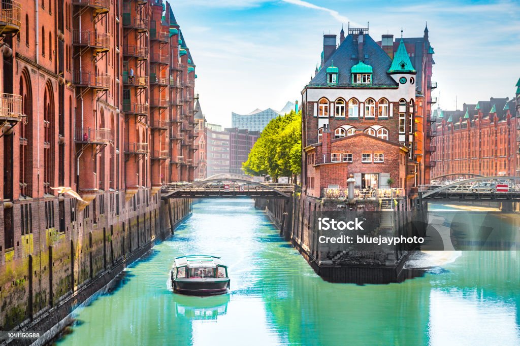 Hamburg Speicherstadt with sightseeing tour boat in summer, Germany Classic view of famous Hamburg Speicherstadt warehouse district with sightseeing tour boat on a sunny day in summer, Hamburg, Germany Hamburg - Germany Stock Photo