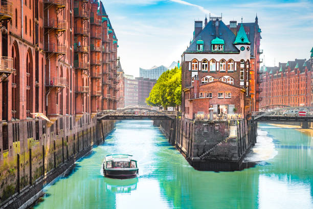 Hamburg Speicherstadt with sightseeing tour boat in summer, Germany Classic view of famous Hamburg Speicherstadt warehouse district with sightseeing tour boat on a sunny day in summer, Hamburg, Germany aussenalster lake stock pictures, royalty-free photos & images