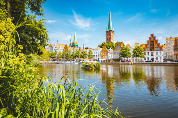 historic city of luebeck with trave river in summer, schleswig-holstein, germany - schleswig imagens e fotografias de stock