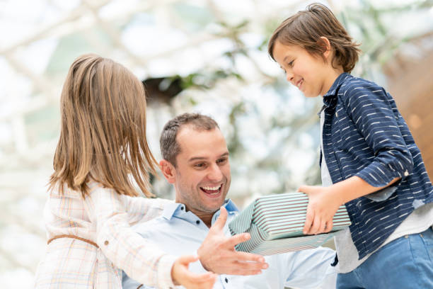 istock Kids surprising their father with a gift for Father's Day 1041155196