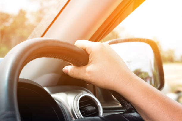 istock hand women driving car 1041157364