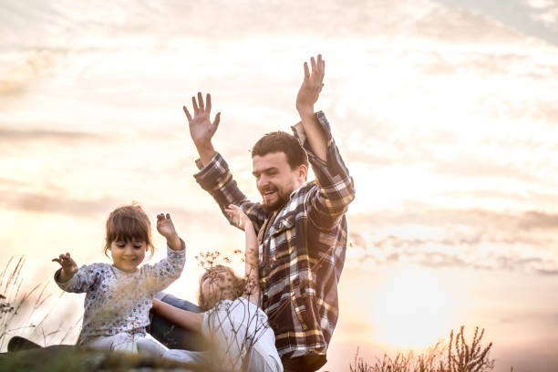 istock dad playing with two little cute daughters 1041159842