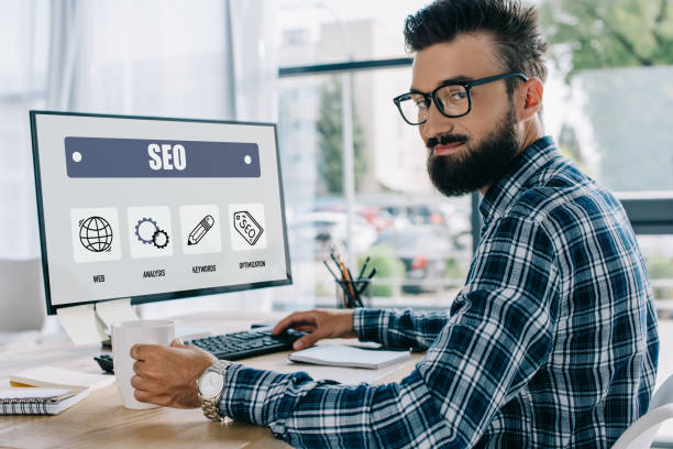 istock young successful seo manager sitting at workplace with computer and looking at camera 1041160264