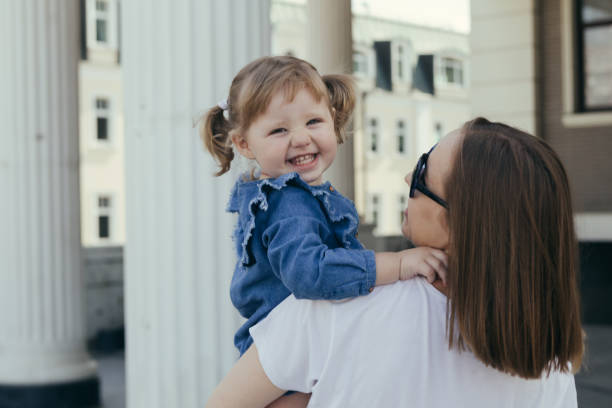 istock Mother carrying daughter in her arms 1041161094