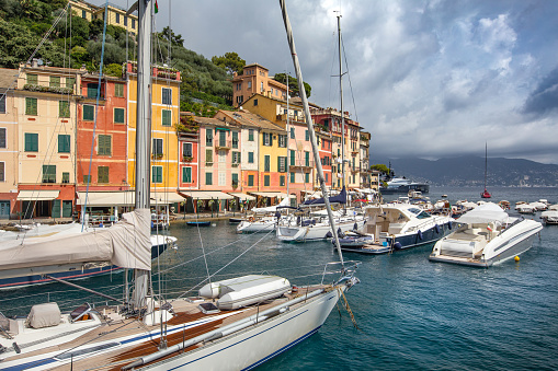 Small sailing boats moored in the beautiful small fishing port of Portofino bay. It is coastal gem situated near Genoa. famed for its picturesque harbour and celebrity visitors.