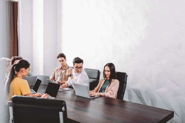 istock multicultural business partners having meeting at table with laptops in modern office 1041164064