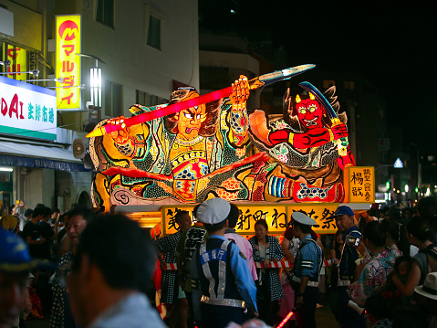 The 15th Sakurashinmachi Nebuta Matsuri (2018) - Erlang Shen, Chinese God with a third truth-seeing eye in the middle of his forehead\nTokyo, Japan - September 8, 2018: Spectators taking pictures with their devices of Erlang Shen themed nebuta parade float at the 15th Sakurashinmachi Nebuta Matsuri  Er-lang Shen may be a deified version of several semi-mythical folk heroes who help regulate China's torrential floods, dating variously from the Qin, Sui and Jin dynasties (#). A later Buddhist source identify him as the second son of the Northern Heavenly King Vaishravana. Erlang Shen is well known in Asia.