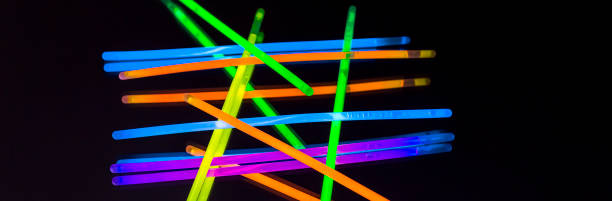 istock Colorful fluorescent light neon big glow stick on mirror reflection black background 1041164748