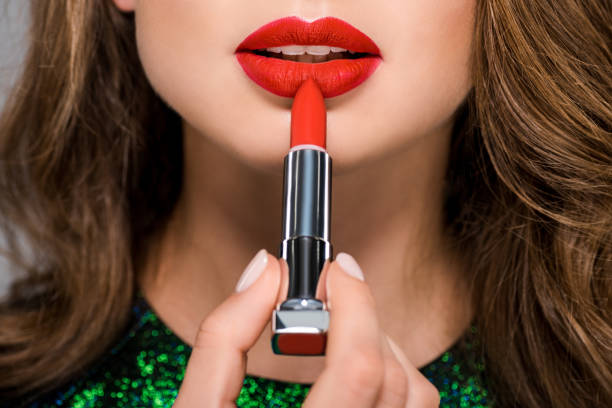 cropped shot of woman with red lipstick isolated on grey stock photo