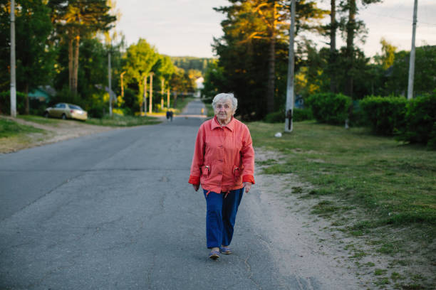 istock An elderly woman strolls through the village. 1041167276