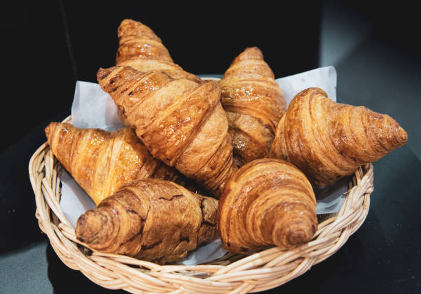 istock French croissants on wicker basket, bakery background 1041175308