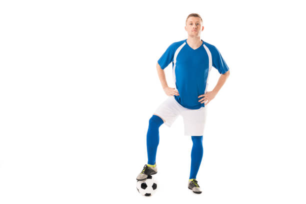 istock confident young soccer player standing with hands on hips and looking at camera isolated on white 1041175902