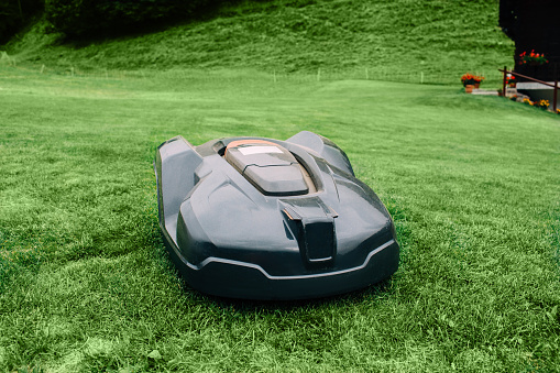 Robotic lawn mower on grass, automated lawn mower