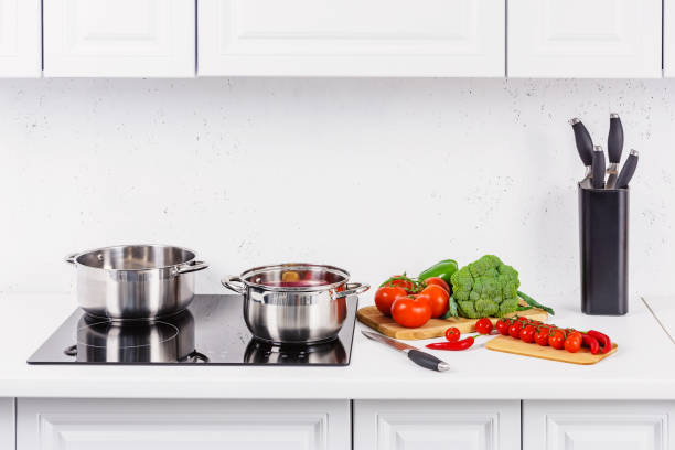 istock ripe vegetables on kitchen counter, pans on electric stove in light kitchen 1041182884