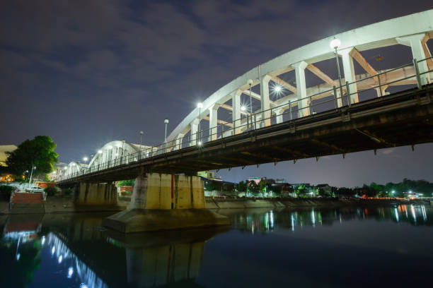 istock White stone bridge on water reflection across river under clear sky of night time 1041191228