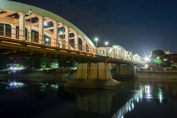 istock White stone bridge on water reflection across river under clear sky of night time 1041191282