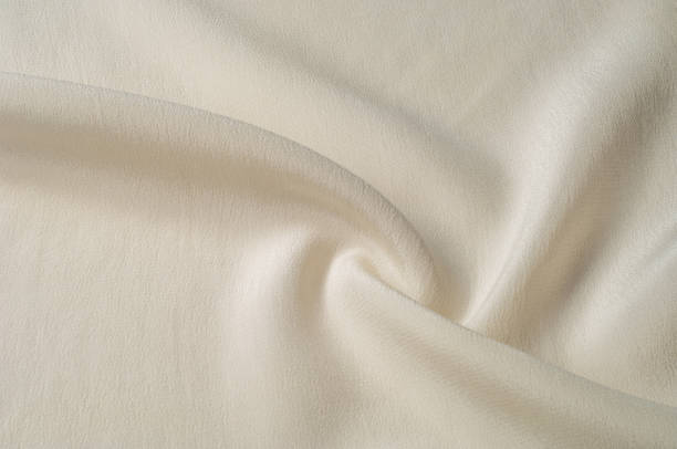 istock Texture background pattern. White silk fabric. Closeup of a rippled white silk fabric. Advertising space. Smooth elegant white silk can be used as a wedding background. 1041193822