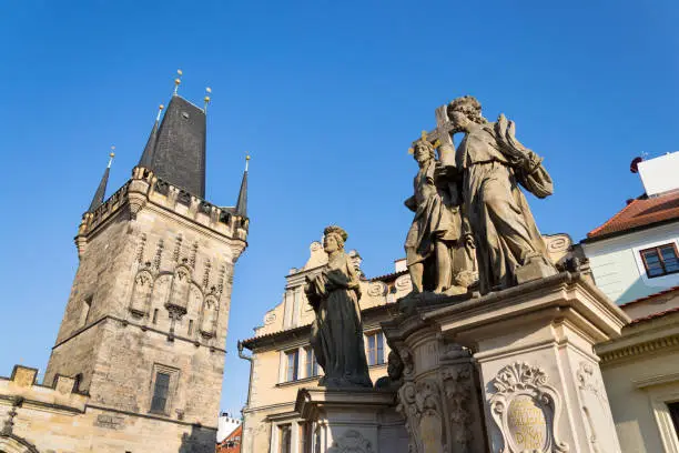 Statue of Holy Savior with Saints Cosmas and Damian detail on Charles Bridge, Mala Strana, Prague, Czech Republic, sunny day