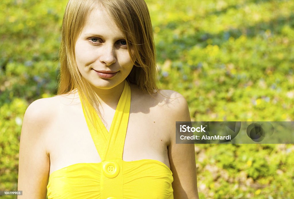 Girl smiling in sunny spring field. Copy space  Adult Stock Photo