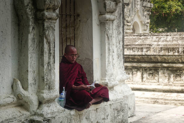 istock Monk reading the book. Mandalay city, Myanmar 1041204992