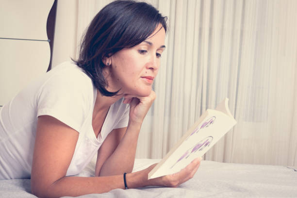 istock girl on the bed reading a book 1041210048