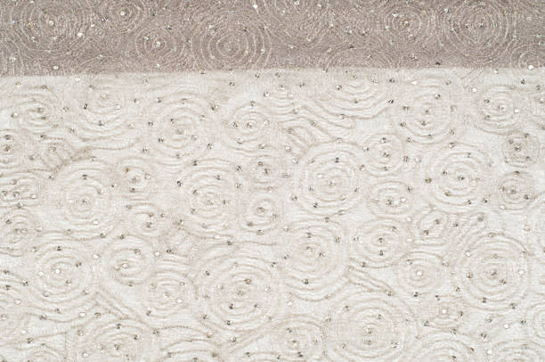 istock Texture, fabric, background. Lace fabric with a pattern of a circle, with a thread of gold thread 1041213550