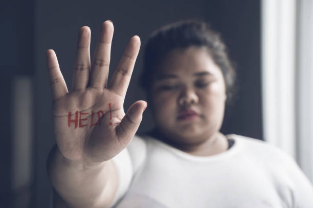 istock Asian obese woman showing help word 1041214672