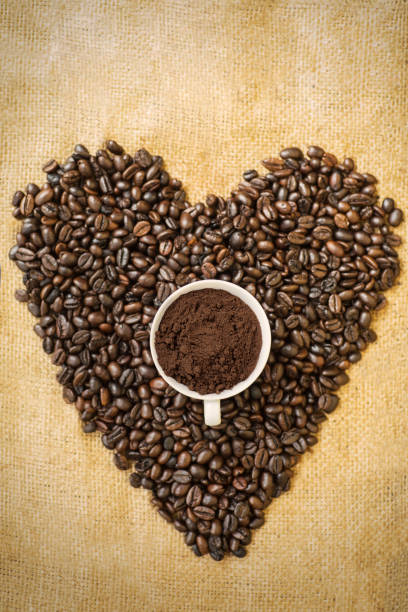 istock Coffee beans shaped heart symbol with a cup 1041214678