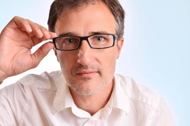 istock Attractive middle-aged man adjusting the glasses staring 1041215064