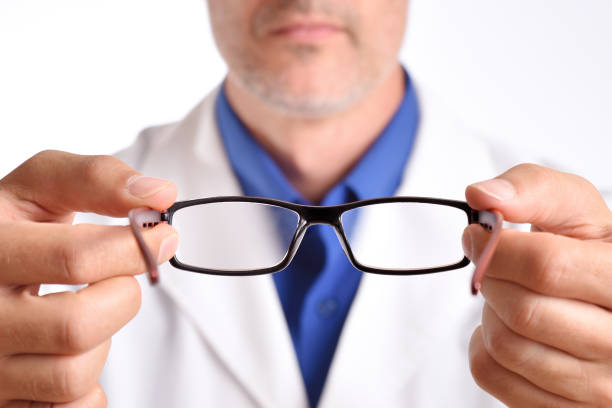 istock Doctor putting glasses on patient close up 1041215072