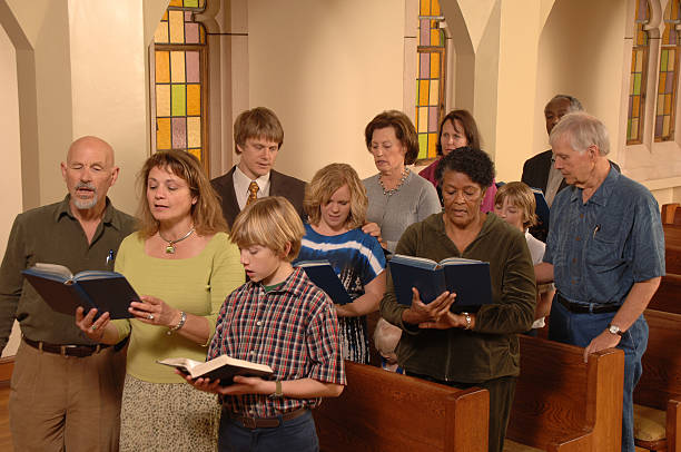 Singing Hymns in Church  anglican stock pictures, royalty-free photos & images