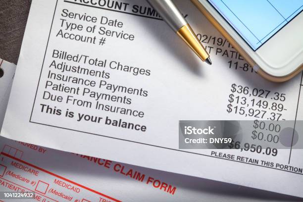 Smart Phone And Ballpoint Pen On Top Of Medical Invoice Stock Photo - Download Image Now