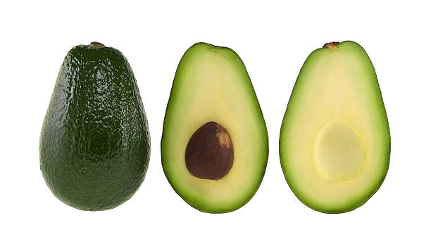 A whole and halved avocado on white stock photo