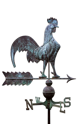 Weathered copper rooster weathervane isolated on white background, full frame vertical composition with copy space and clipping path included