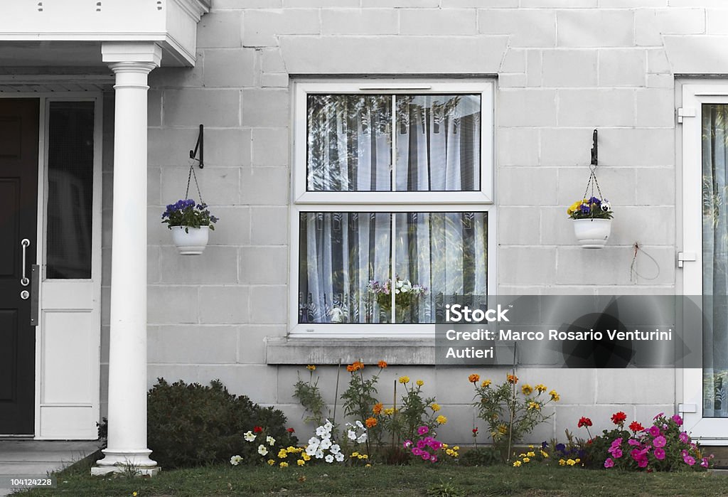 Pretty English house with flower garden A peaceful and tranquil English house with a small but colourful floreal garden. Front Door Stock Photo