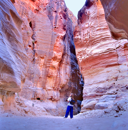 PETRA,JORDAN-SEPTEMBER 12,2015: The Siq, the narrow slot-canyon that serves as the entrance passage to the hidden city of Petra, Jordan 