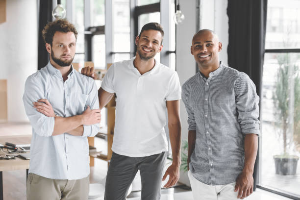 istock multiethnic young businessmen looking at camera while standing in office 1041245776