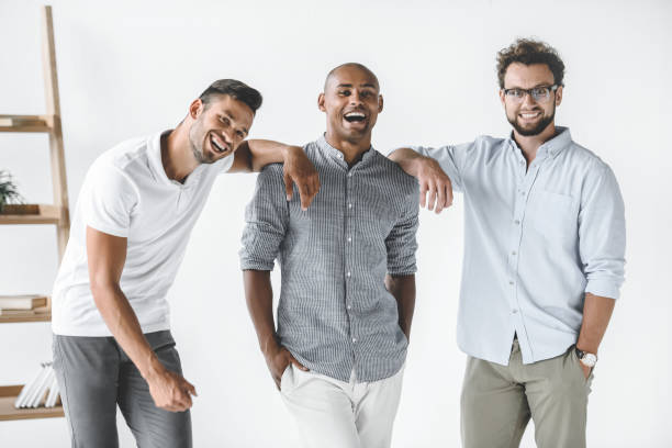 istock multiethnic group of young smiling businessmen standing in light office 1041245882