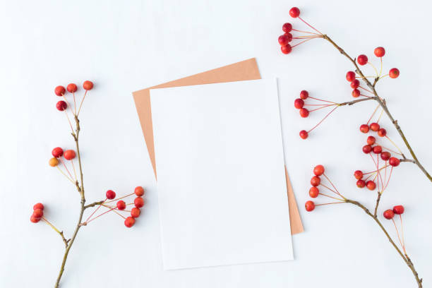 Mockup blank paper card and branch with small red apples