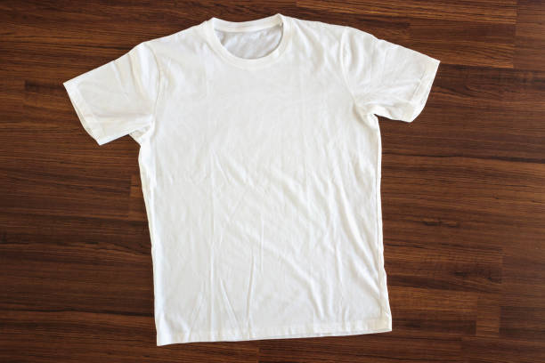 istock White t-shirt on wood background 1041255844