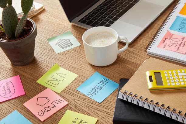 istock note paper sheets with business strategy, calculator and laptop on tabletop 1041260402