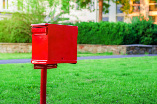 istock Mailbox red color on a column on a green background 1041267268