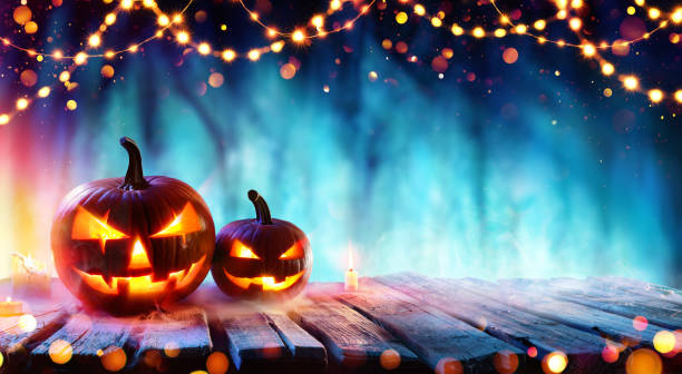 istock Halloween Party - Pumpkins On Table In Dark Forest 1041271428