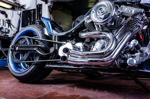 Detail on a modern motorcycle in the workshope. Motorcycle Exhaust. selective focus