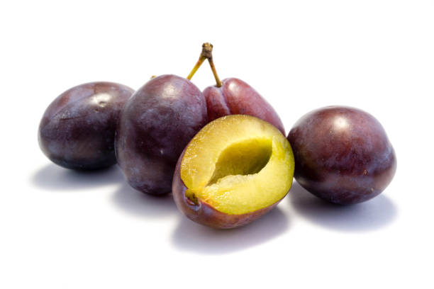 istock Four blue plums and one cut open isolated on white background 1041278738